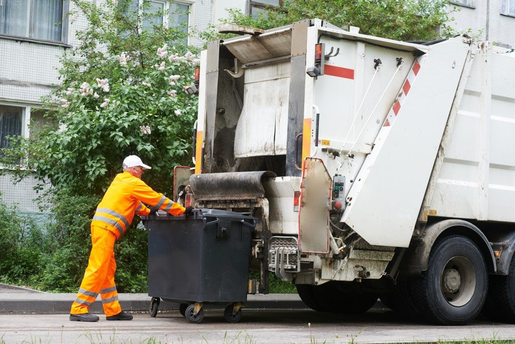 garbage disposal guy taking the trash