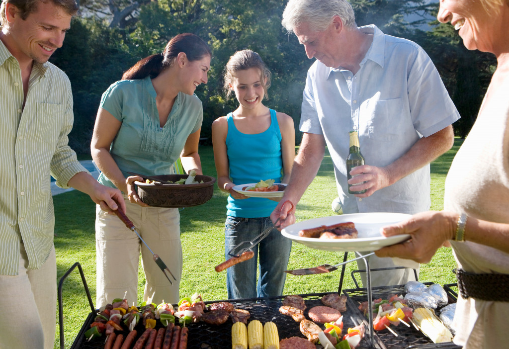 a family having a barbecue in the backyard