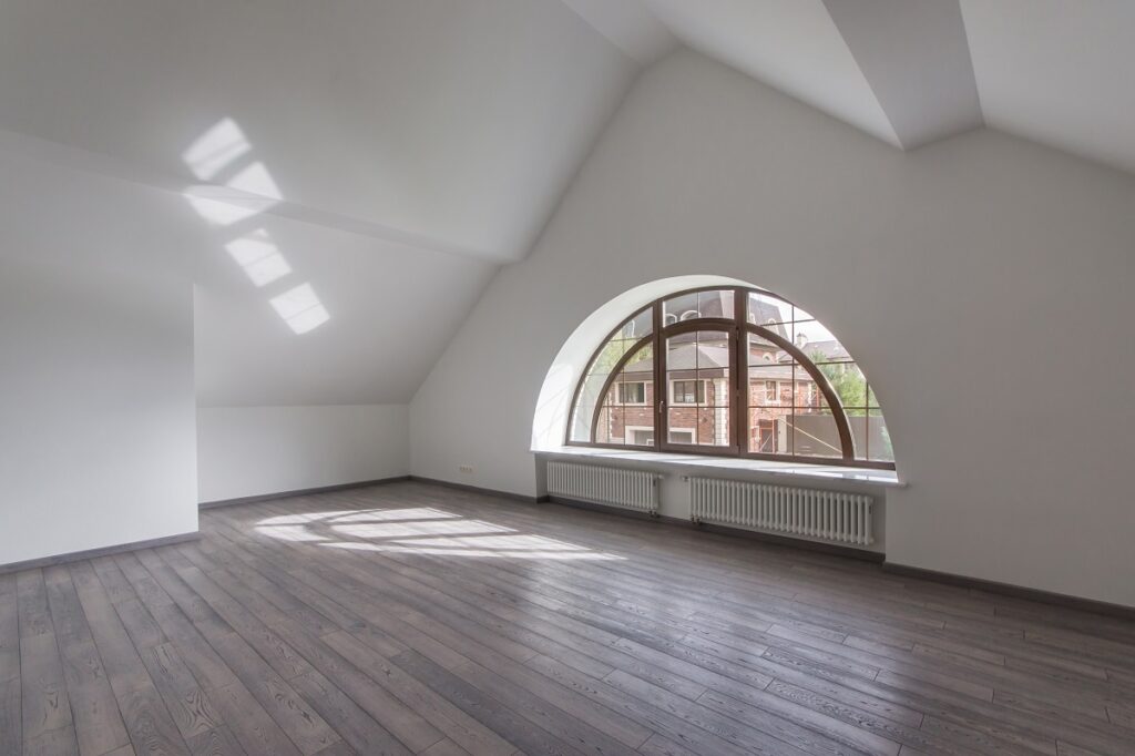 attic with natural light coming from a window