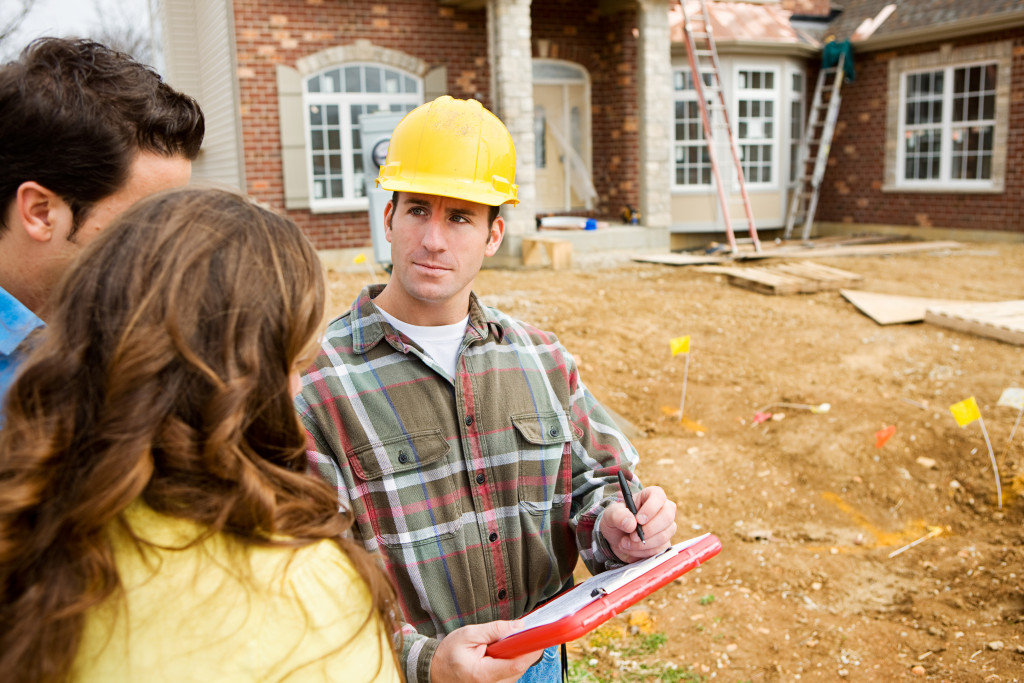 A contractor talking to property owners about construction needs