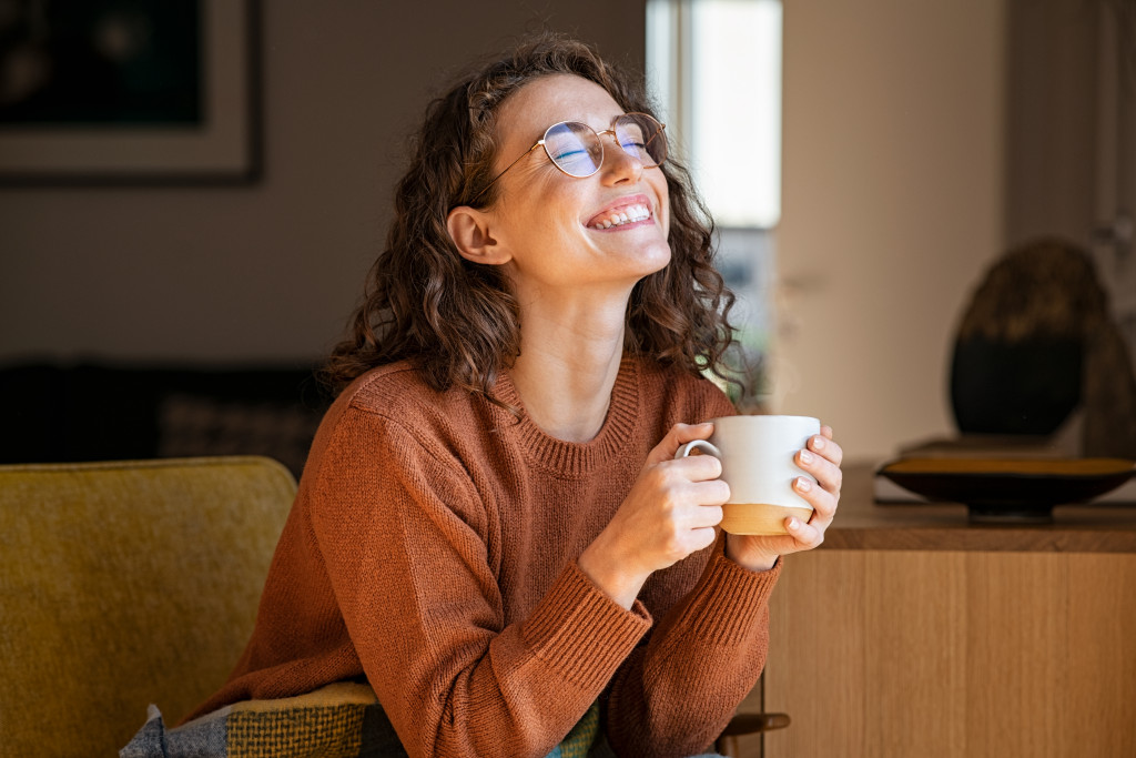 woman enjoying her cup of coffee at home