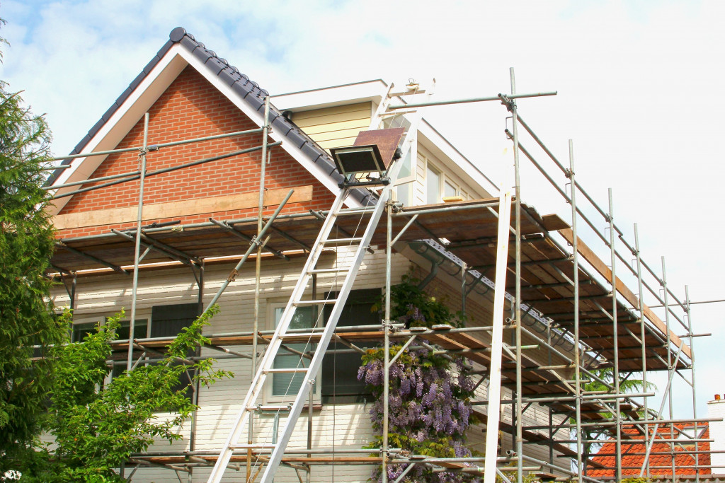 House under construction with equipment outside the house.