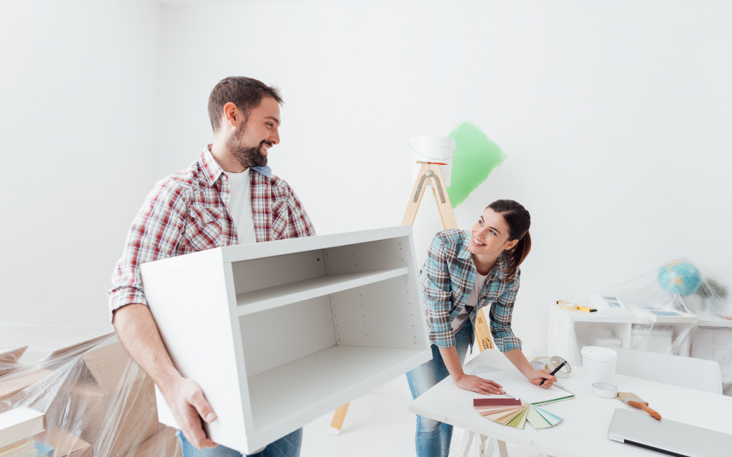 boy carrying a white furniture