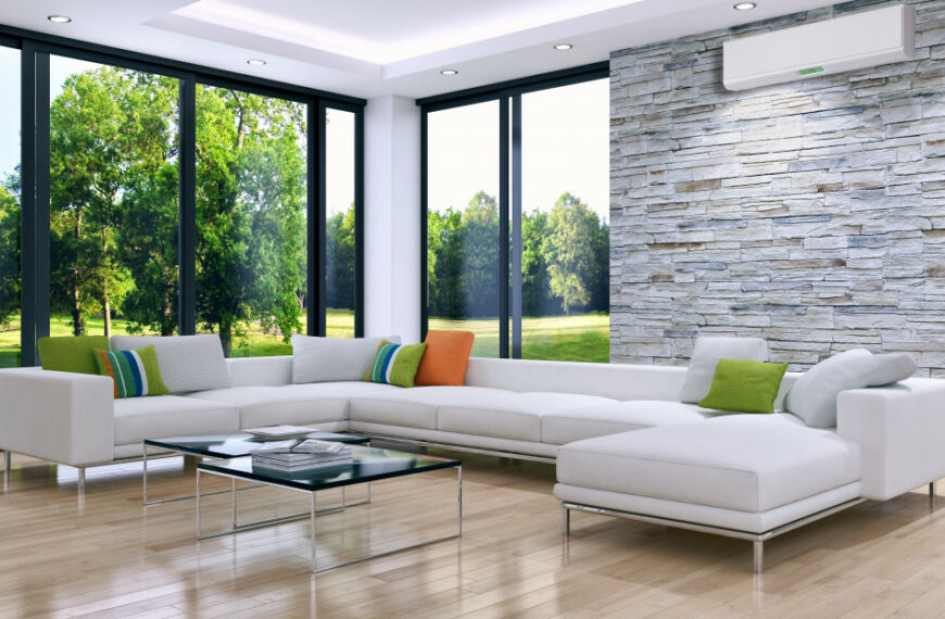 Bright living area with an air conditioner and floor to ceiling windows.