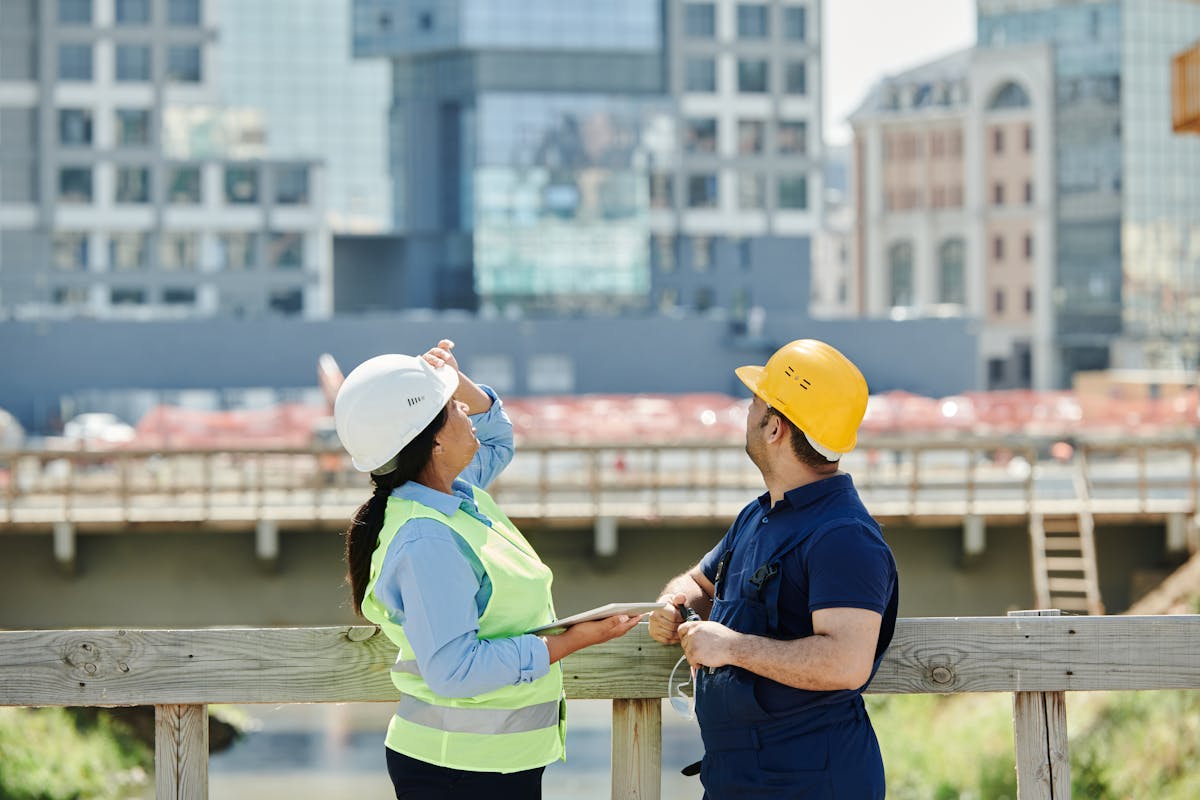 two engineers looking at the buildings they are constructing